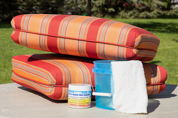 Woolite is a good, mild detergent to try cleaning outdoor fabrics with